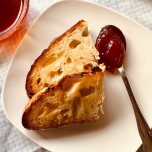 two slices of rustic no-knead bread with jam
