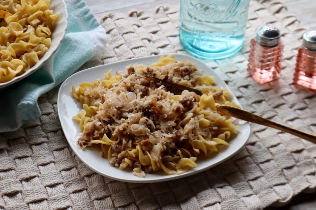 A plate full of Fried Sauerkraut with Sausage and Buttered Noodles