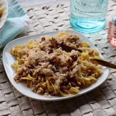 A plate full of Fried Sauerkraut with Sausage and Buttered Noodles