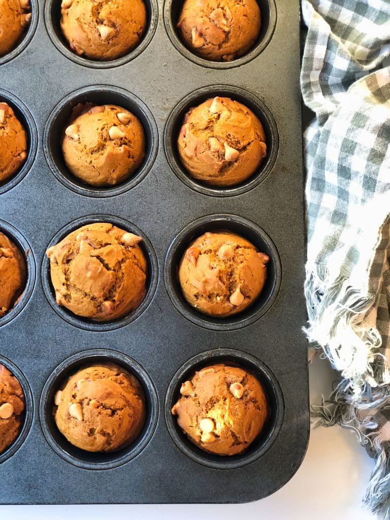 A muffin tin with fresh from the oven Pumpkin Butterscotch Muffins