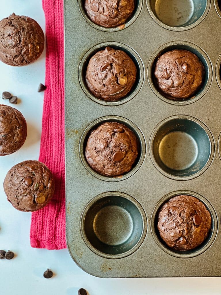 A muffin tin filled with Double Chocolate Zucchini Muffins with Buttermilk just out of the oven