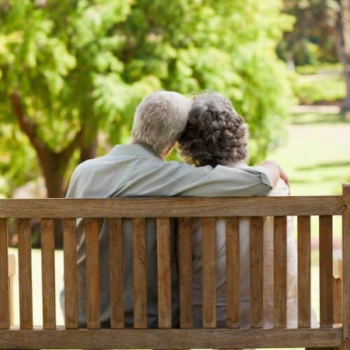 An elderly couple holding hands is an example of how to Nurture Your Marriage