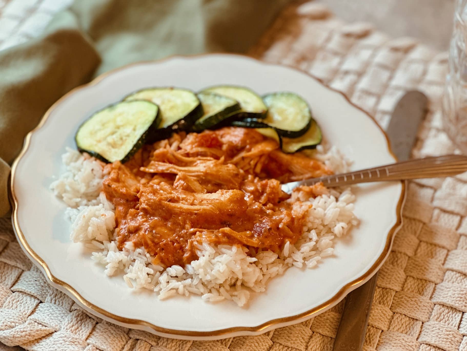 A plate heaped with slow-cooker butter chicken sauce over rice.