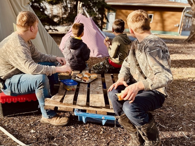 Kids eating supper outside in spring